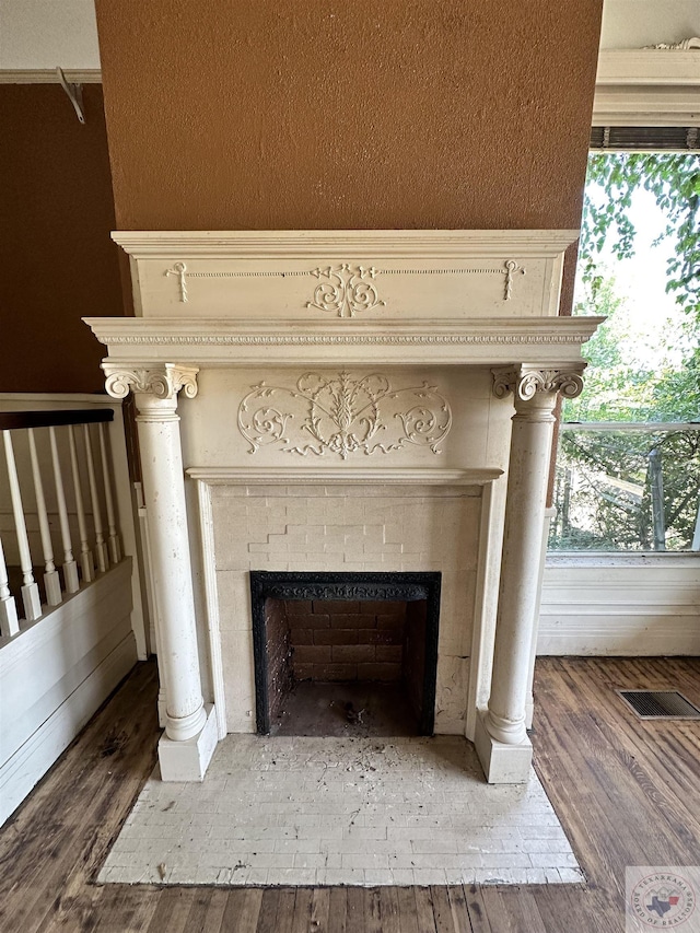 room details with wood-type flooring and a tiled fireplace