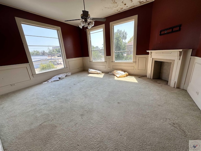 interior space with carpet flooring, a water view, and ceiling fan