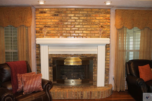 details with ornamental molding, a fireplace, and hardwood / wood-style floors