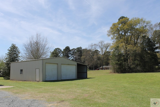 exterior space with a garage and a lawn