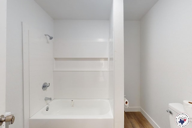 2451 Oaklawn Dr, Texarkana, TX 75501 - full bathroom with baseboards, toilet, bathtub / shower combination, and wood finished floors