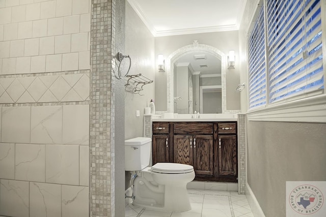 bathroom with toilet, vanity, and ornamental molding