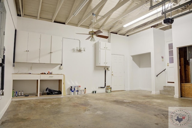 garage with ceiling fan, wooden ceiling, and a garage door opener