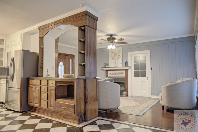 interior space with ceiling fan and ornamental molding