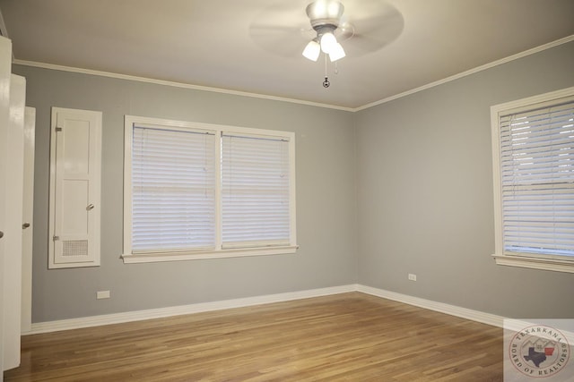 empty room featuring hardwood / wood-style flooring, ornamental molding, and ceiling fan