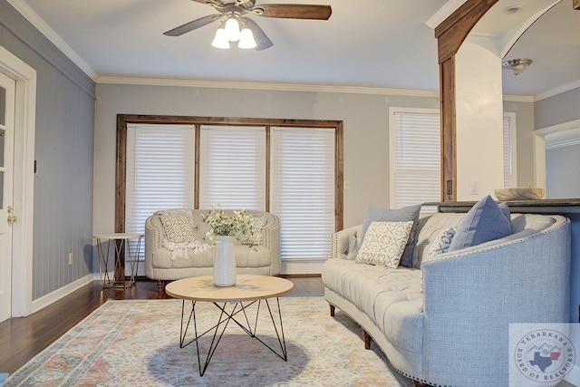 living room with ceiling fan, a wealth of natural light, dark hardwood / wood-style flooring, and ornamental molding