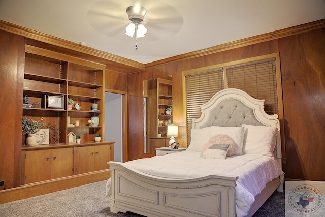 carpeted bedroom featuring wooden walls, ceiling fan, and ornamental molding