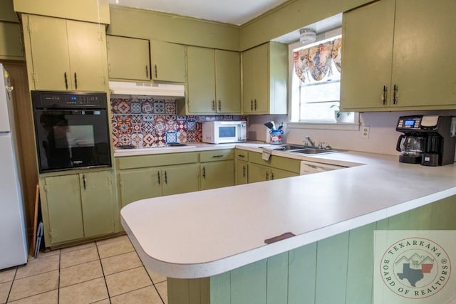 kitchen featuring white appliances, sink, backsplash, kitchen peninsula, and light tile patterned floors