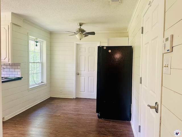 5 Arnold Dr, Texarkana, AR 71854 - unfurnished room featuring ceiling fan, dark wood finished floors, a textured ceiling, ornamental molding, and wood walls