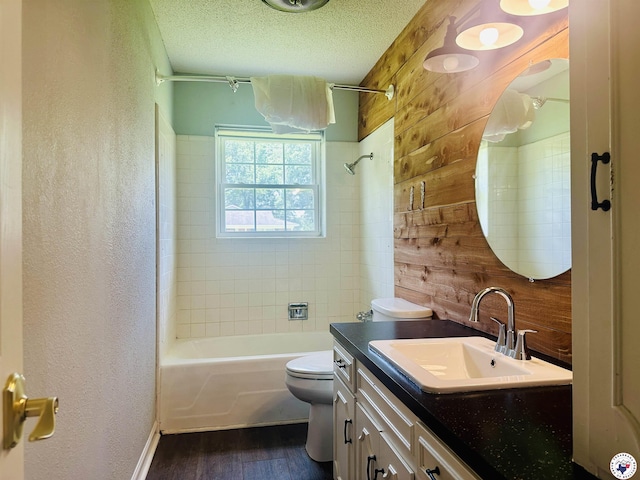 5 Arnold Dr, Texarkana, AR 71854 - full bath with wood finished floors, vanity, shower / washtub combination, a textured wall, and wood walls