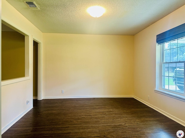 5 Arnold Dr, Texarkana, AR 71854 - spare room with dark wood-style flooring and a textured ceiling