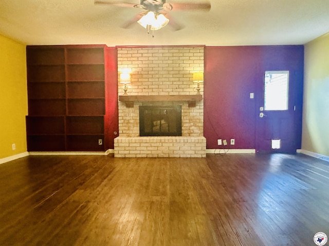 5 Arnold Dr, Texarkana, AR 71854 - unfurnished living room with wood finished floors, ceiling fan, built in shelves, a fireplace, and a textured ceiling