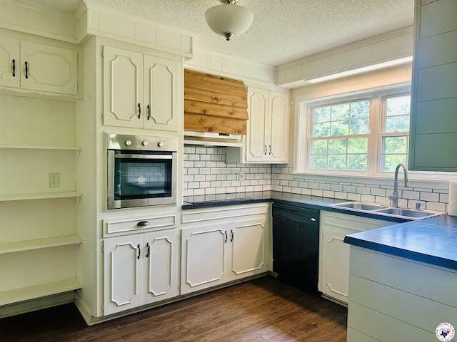 5 Arnold Dr, Texarkana, AR 71854 - kitchen featuring dishwasher, oven, dark countertops, a textured ceiling, and backsplash
