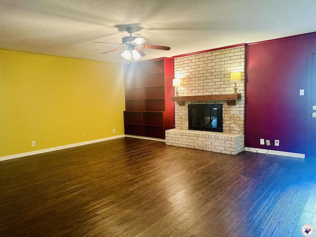 5 Arnold Dr, Texarkana, AR 71854 - unfurnished living room with a ceiling fan, a textured ceiling, wood-type flooring, a brick fireplace, and built in shelves