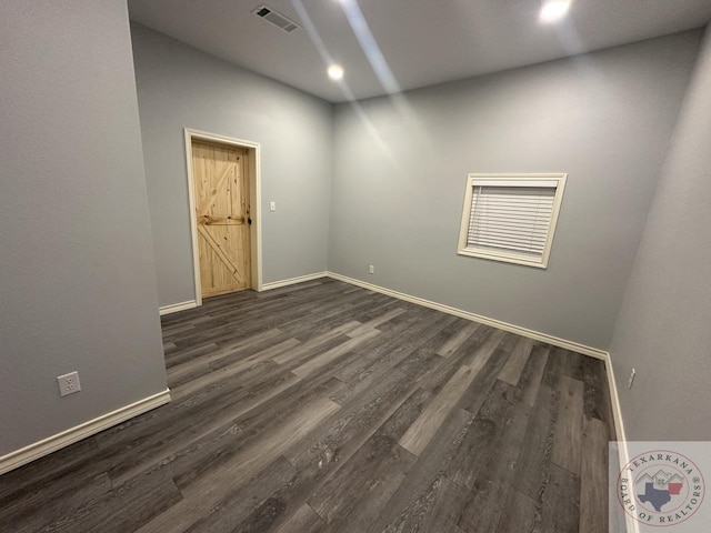 spare room with dark hardwood / wood-style floors