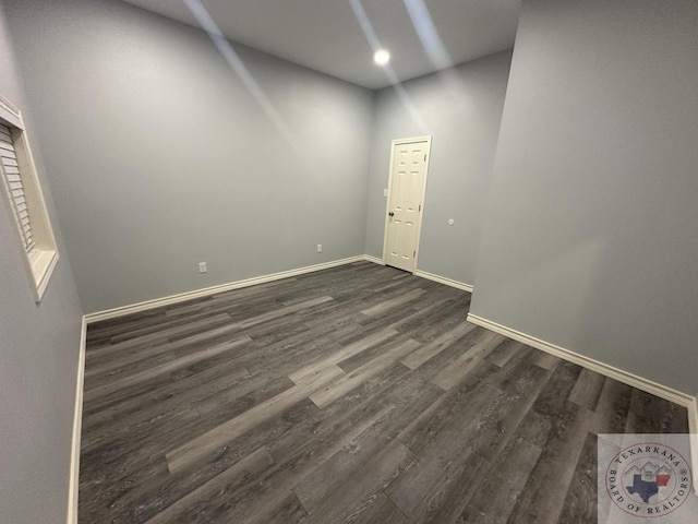 spare room featuring dark hardwood / wood-style flooring