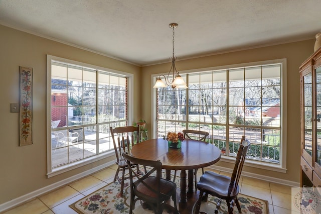 dining space featuring a textured ceiling, light tile patterned floors, plenty of natural light, and crown molding