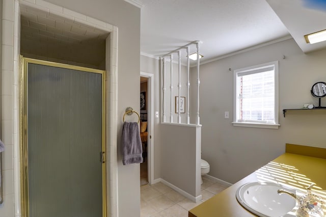 bathroom featuring a shower with shower door, vanity, ornamental molding, and tile patterned flooring