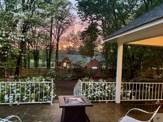 patio terrace at dusk with an outdoor fire pit