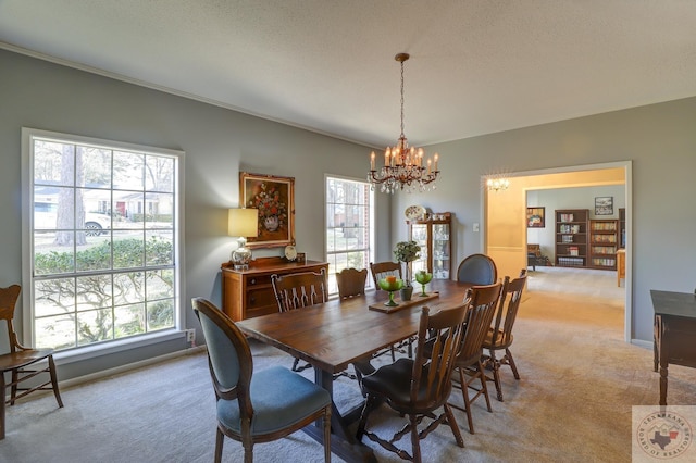 dining room featuring a chandelier and light colored carpet