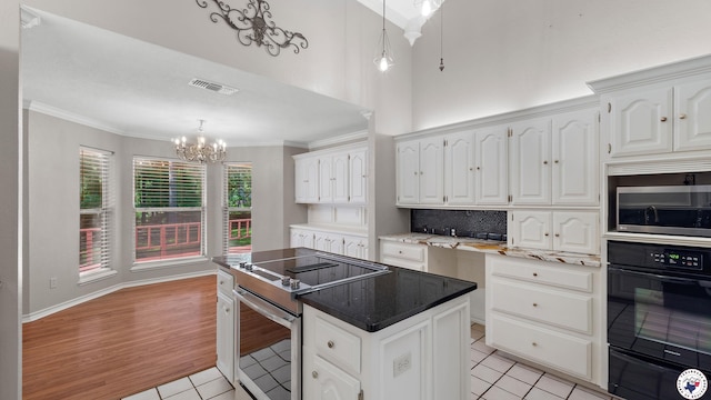2 Spring Valley Ln, Texarkana, AR 71854 - kitchen featuring appliances with stainless steel finishes, light tile patterned floors, a warming drawer, a chandelier, and white cabinets