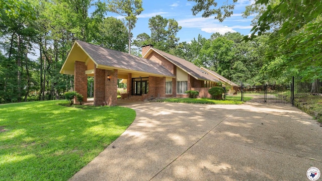 2 Spring Valley Ln, Texarkana, AR 71854 - view of front facade featuring driveway, a gate, brick siding, a chimney, and roof with shingles