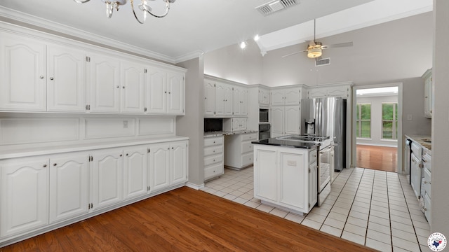 2 Spring Valley Ln, Texarkana, AR 71854 - kitchen with a center island, white cabinetry, a chandelier, crown molding, and light tile patterned floors