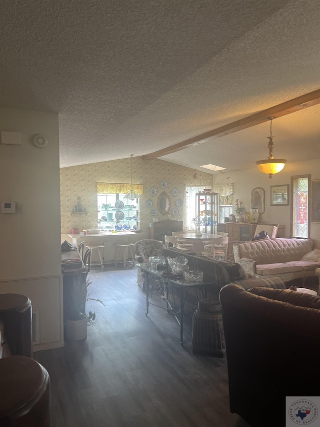 living room with vaulted ceiling, a wealth of natural light, a textured ceiling, and wood-type flooring