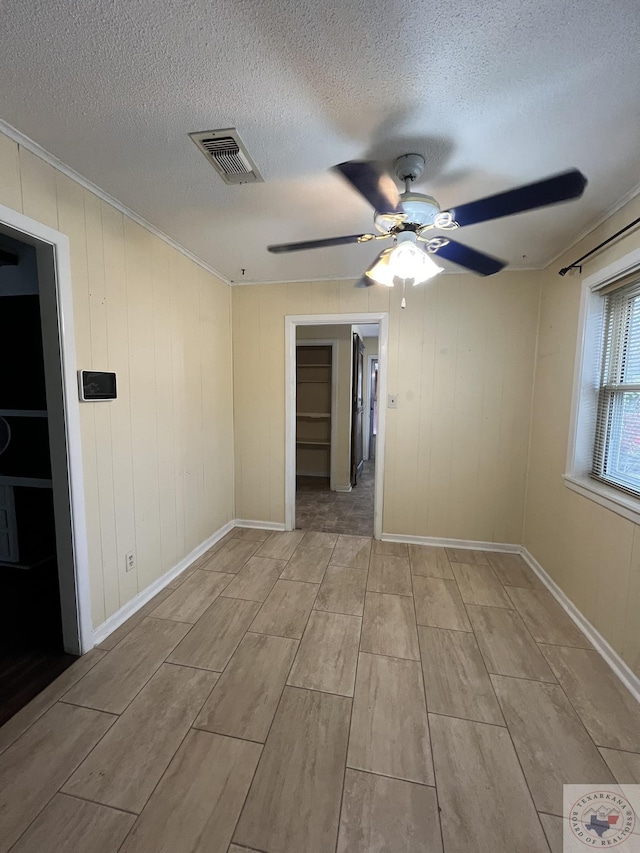 30 Broadmoor Dr, Texarkana, AR 71854 - spare room featuring wood finish floors, a ceiling fan, a textured ceiling, ornamental molding, and baseboards