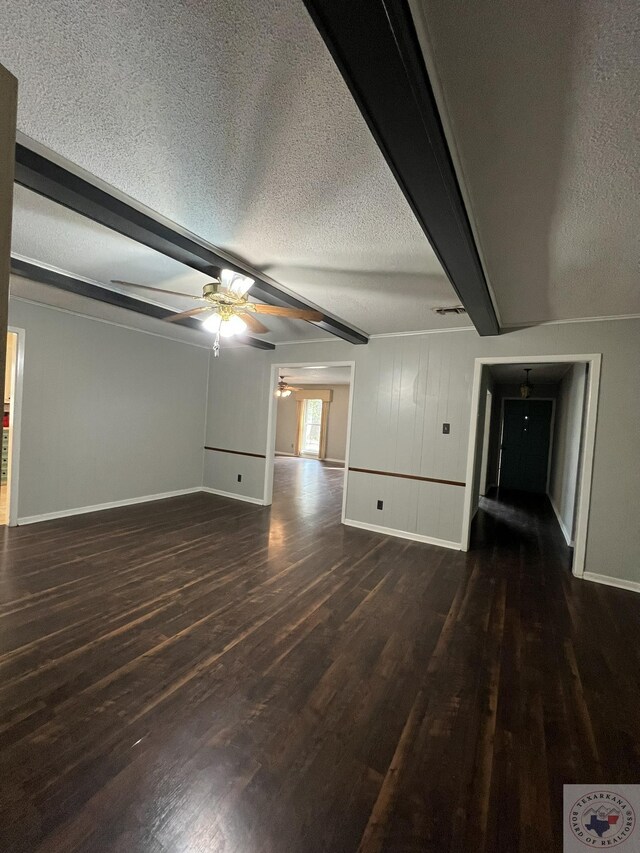30 Broadmoor Dr, Texarkana, AR 71854 - unfurnished living room featuring ceiling fan, beam ceiling, dark wood-style flooring, baseboards, and a textured ceiling