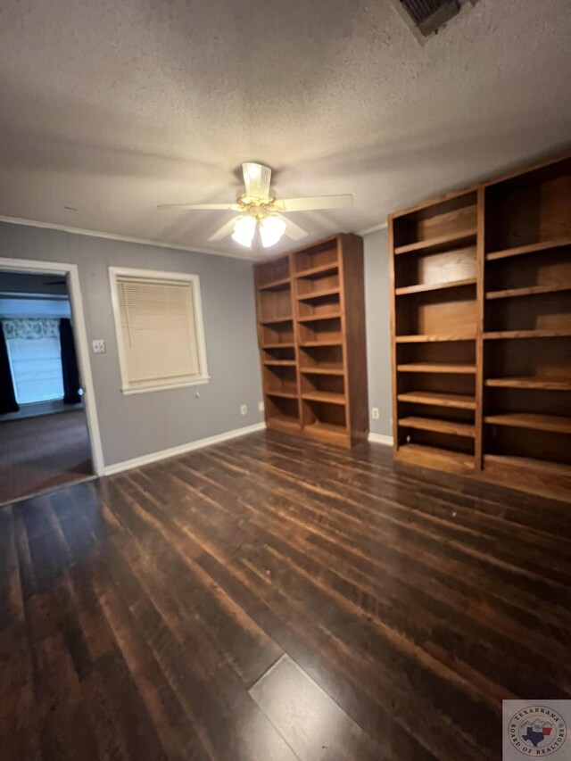 30 Broadmoor Dr, Texarkana, AR 71854 - unfurnished living room with baseboards, wood finished floors, a ceiling fan, a textured ceiling, and built in shelves