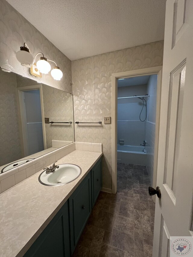30 Broadmoor Dr, Texarkana, AR 71854 - bathroom featuring vanity, a textured ceiling, wallpapered walls, shower / tub combination, and stone finish flooring