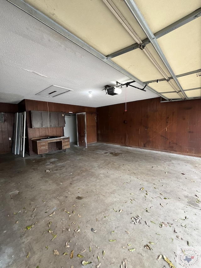 30 Broadmoor Dr, Texarkana, AR 71854 - garage featuring a garage door opener and wood walls