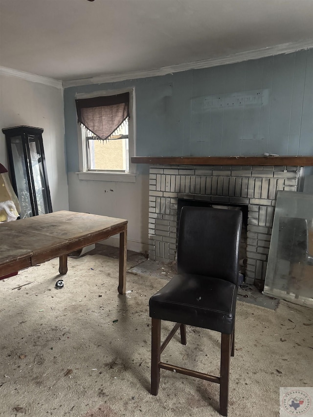 sitting room featuring a brick fireplace and crown molding