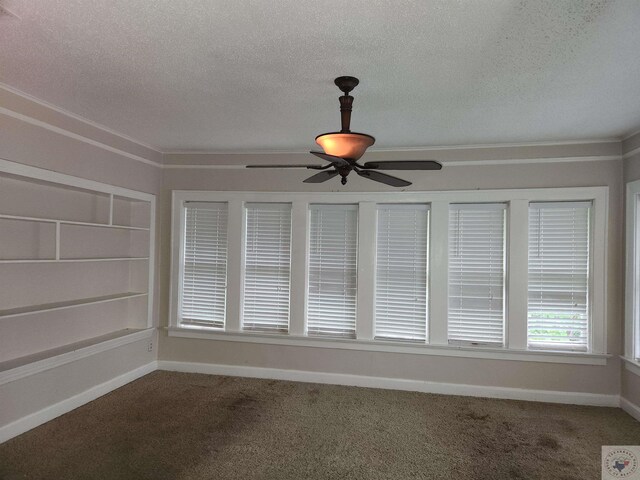 unfurnished sunroom featuring ceiling fan