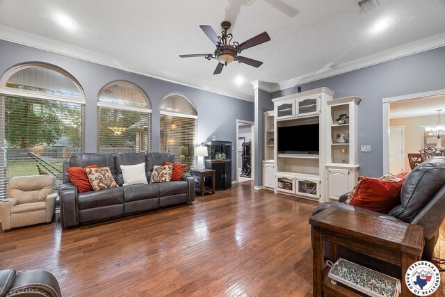 6404 N Park Rd, Texarkana, TX 75503 - living room with ornamental molding, ceiling fan with notable chandelier, dark wood-type flooring, and visible vents