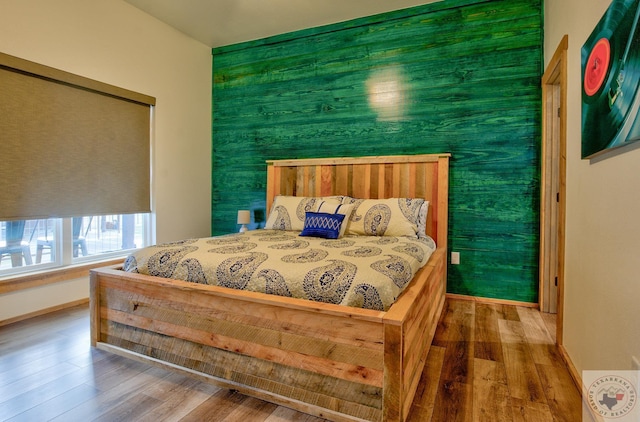 bedroom with hardwood / wood-style floors and a closet