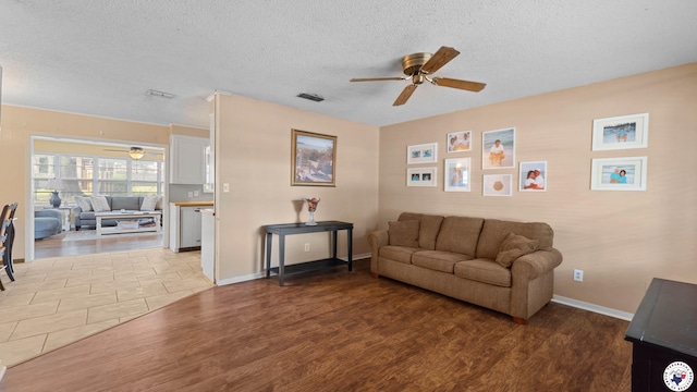 4133 Minden Ave, Texarkana, AR 71854 - living area with a ceiling fan, wood finished floors, baseboards, and a textured ceiling
