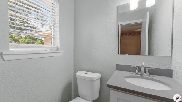 4133 Minden Ave, Texarkana, AR 71854 - bathroom with vanity, toilet, and a textured wall