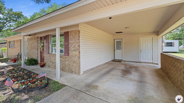 4133 Minden Ave, Texarkana, AR 71854 - doorway to property with brick siding and an attached carport