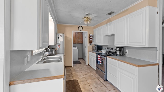 4133 Minden Ave, Texarkana, AR 71854 - kitchen featuring appliances with stainless steel finishes, a sink, washer / clothes dryer, a ceiling fan, and white cabinetry