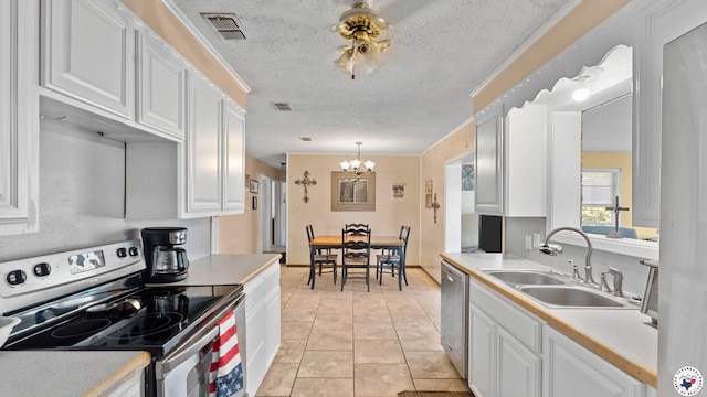 4133 Minden Ave, Texarkana, AR 71854 - kitchen with appliances with stainless steel finishes, a sink, white cabinets, a chandelier, and light countertops