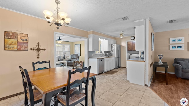 4133 Minden Ave, Texarkana, AR 71854 - dining room featuring ceiling fan, light tile patterned floors, a textured ceiling, a chandelier, and ornamental molding