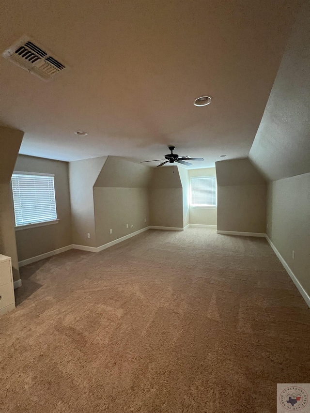 additional living space with carpet floors, lofted ceiling, and ceiling fan