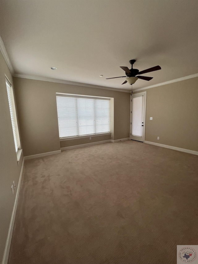 carpeted empty room featuring ceiling fan and crown molding