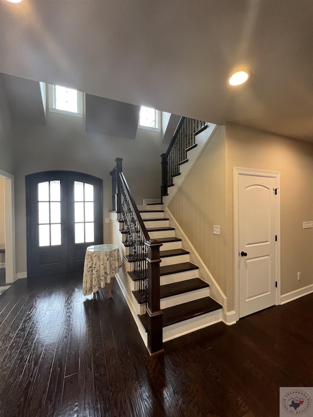 staircase featuring hardwood / wood-style floors and french doors