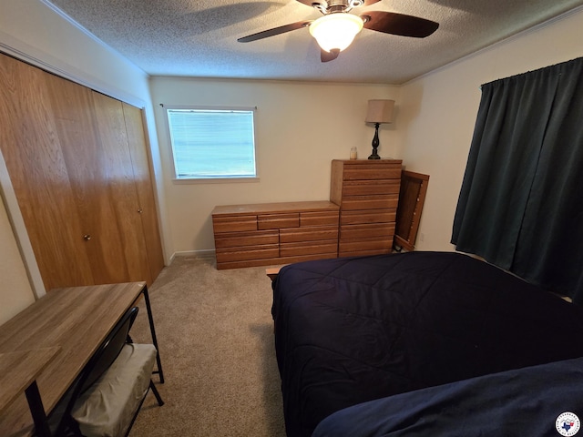 123 Texas Ln, New Boston, TX 75570 - bedroom with carpet flooring, a textured ceiling, a closet, and a ceiling fan
