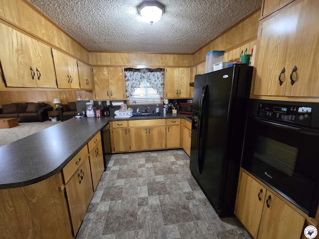 123 Texas Ln, New Boston, TX 75570 - kitchen featuring black appliances, a sink, dark countertops, a peninsula, and a textured ceiling