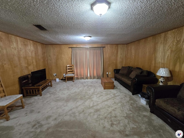 123 Texas Ln, New Boston, TX 75570 - living area featuring wood walls, carpet, and a textured ceiling