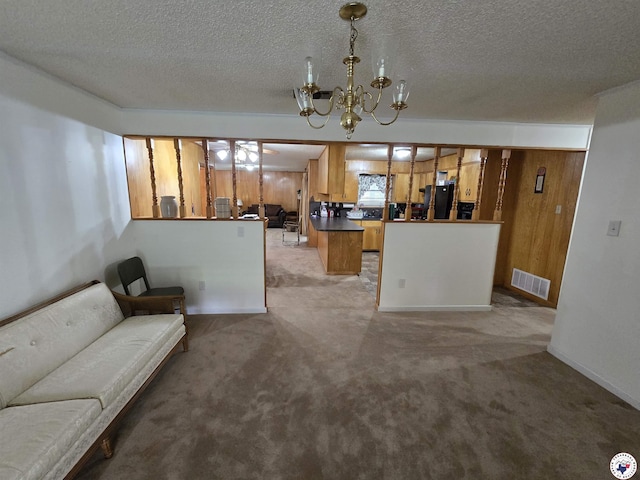 123 Texas Ln, New Boston, TX 75570 - living room with a chandelier, a textured ceiling, light colored carpet, and baseboards